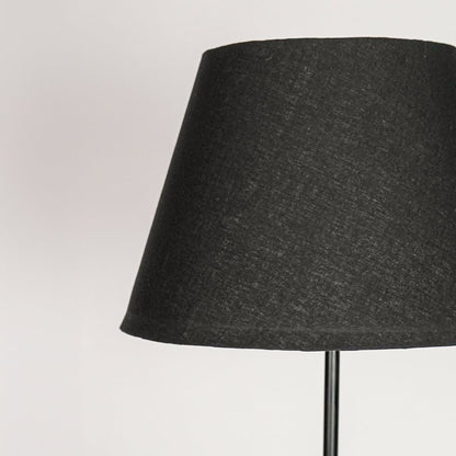 Tapered dark grey fabric lampshade crafted to softly diffuse light for warm ambient interior lighting.