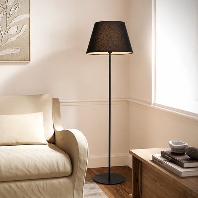 Modern black metal floor lamp with fabric drum shade for living room bedroom corner lounge seating area home decor styling.