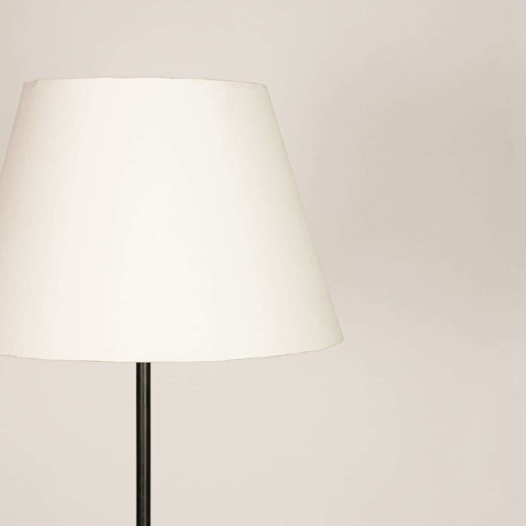 Closeup white fabric tapered shade with smooth finish for soft diffused lighting in modern interior spaces Decor.