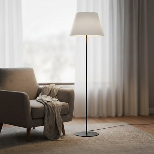 Modern black metal floor lamp with white fabric shade placed in living room corner for soft ambient lighting Decor.