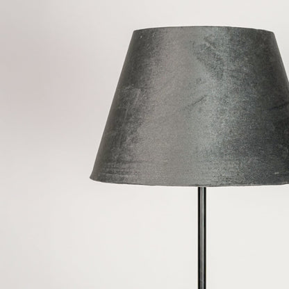 Grey velvet fabric lampshade with tapered silhouette designed to create soft diffused ambient lighting.