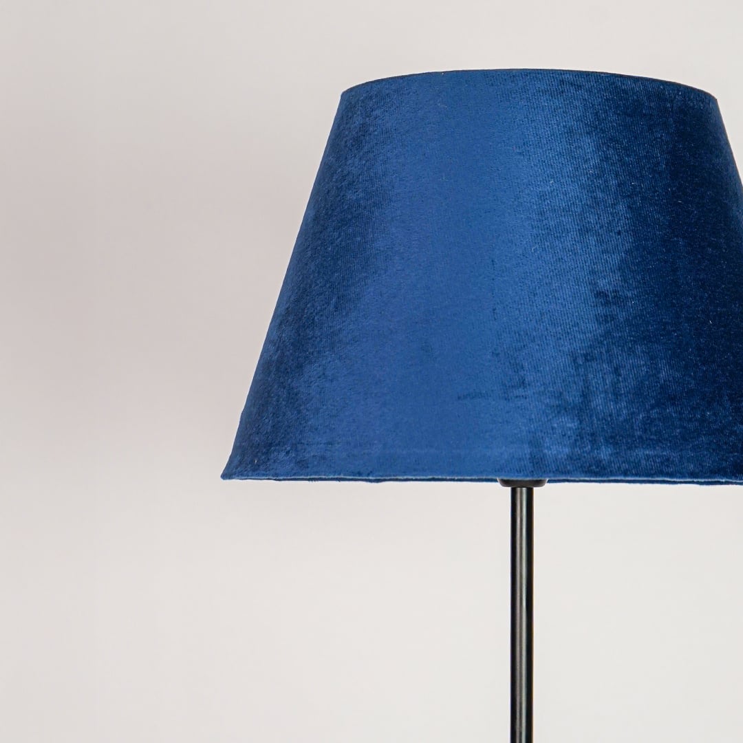 Blue velvet tapered lampshade with soft texture designed to create warm ambient lighting effect.