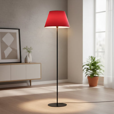 Modern black metal floor lamp with red tapered shade styled in contemporary living room corner setup.