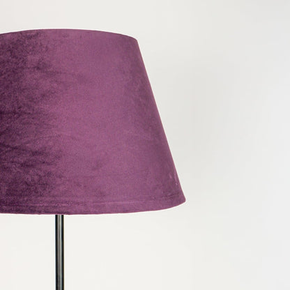 Textured purple fabric lampshade with tapered silhouette designed to softly diffuse warm ambient light.