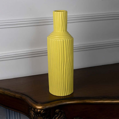 Yellow ribbed ceramic vase displayed on a clean white background ideal for minimal home decor and bold tabletop styling.