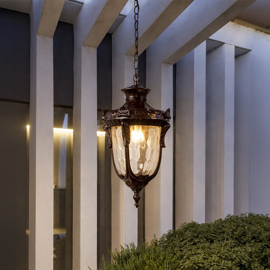 Decorative vintage metal pendant lantern light with warm glow enhancing stylish outdoor entryway decor.