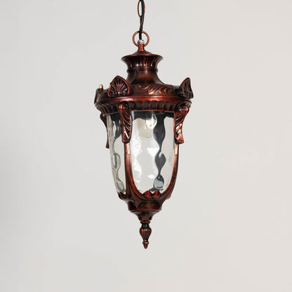 Antique style hanging lantern displayed off on white background showing ornate metal design and curved top.