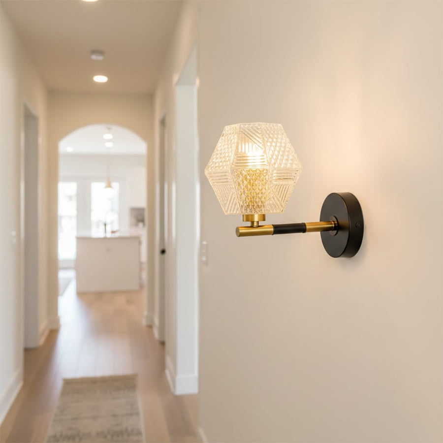 Modern black and gold wall light with textured glass shade for stylish hallway and premium decor spaces.

