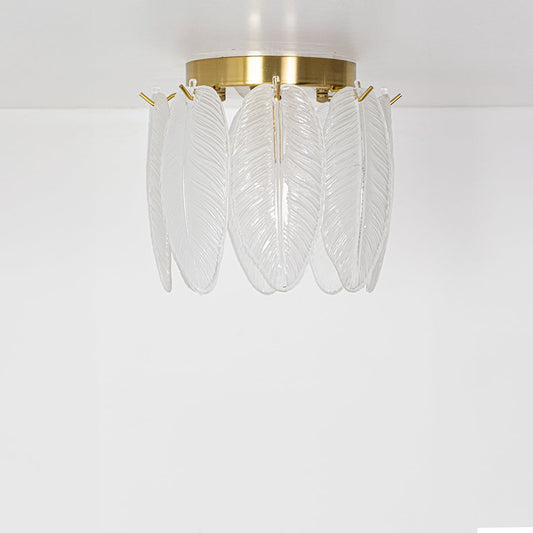 Decorative gold ceiling light with sculpted frosted leaf glass shown with lights off against a white background emphasizing its artistic form.