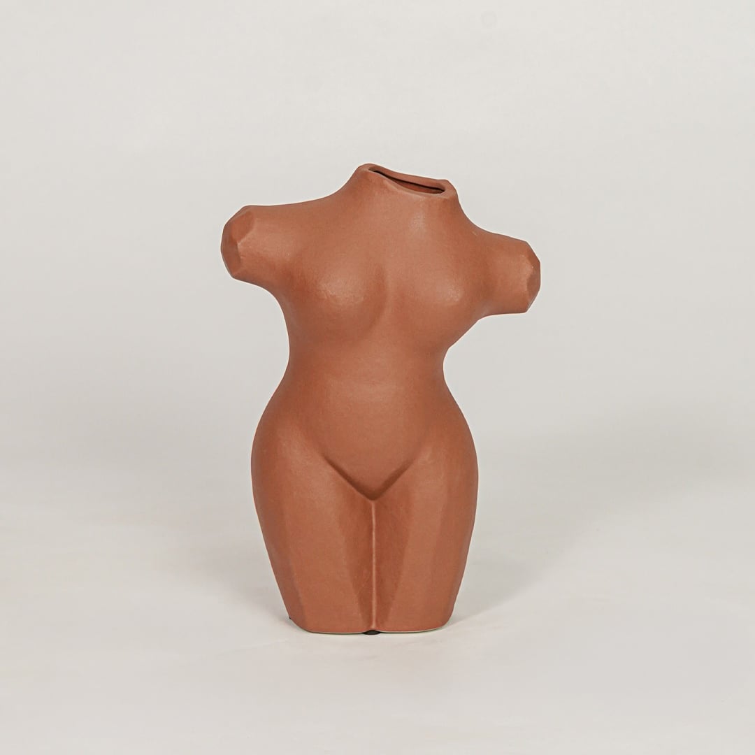 female torso decorative vase brown white background