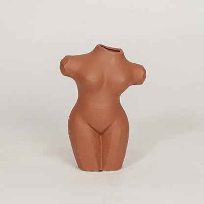 female torso decorative vase brown white background