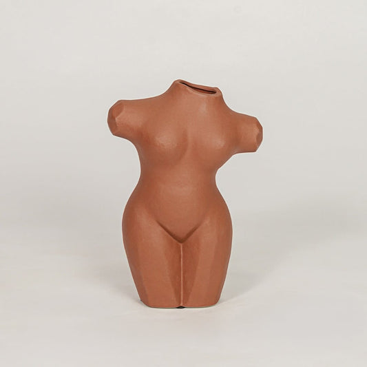 female torso decorative vase brown white background