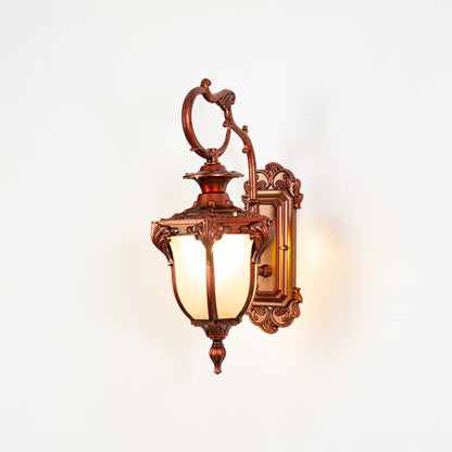 Vintage bronze outdoor wall light on white background with frosted glass shade for classic exterior decor.