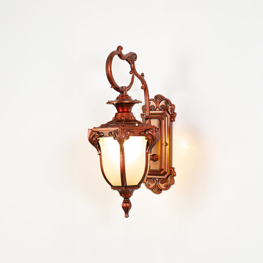Vintage bronze outdoor wall light on white background with frosted glass shade for classic exterior decor.