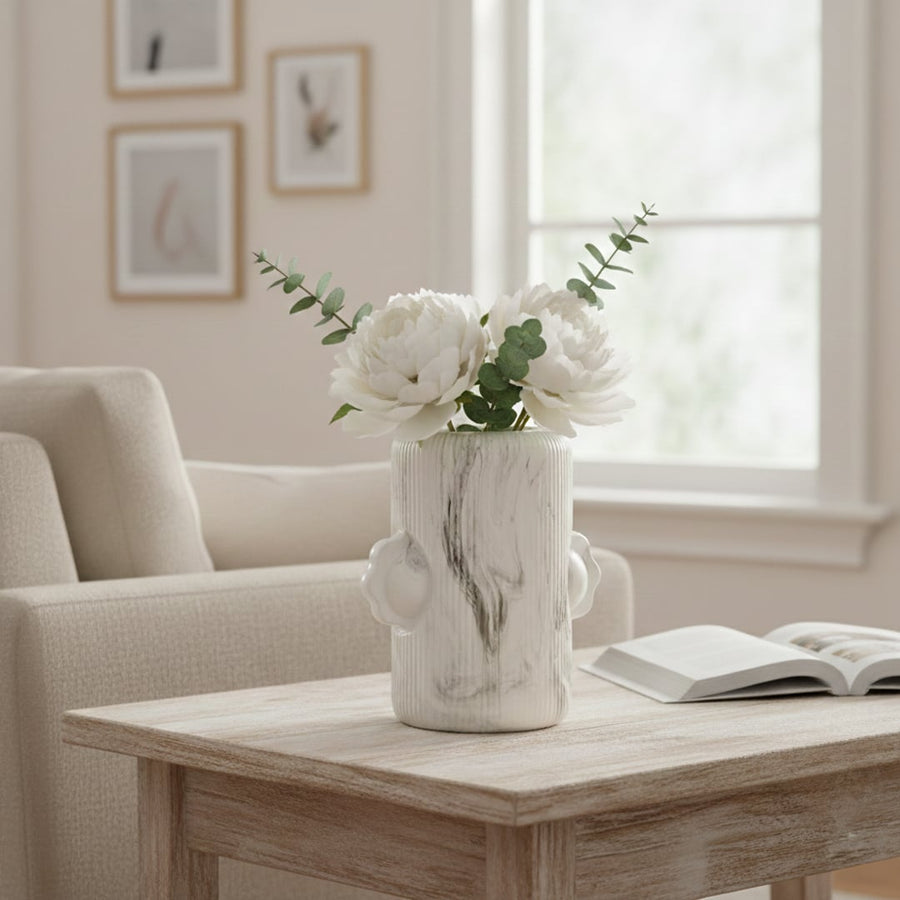White ceramic face vase styled on living room console table adding artistic modern touch to shelf or entryway decor.