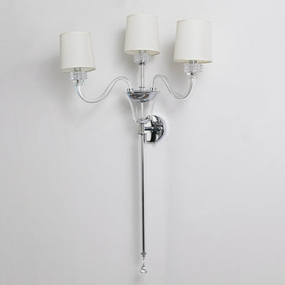 Triple arm wall light with chrome base and fabric shades turned off on white background for wall decor.