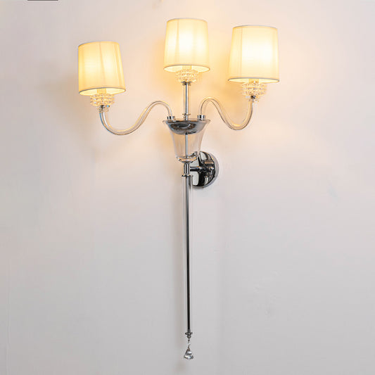 Modern metal wall light in chrome finish with multiple fabric shades for living room or hallway ambient lighting decor placement white background.