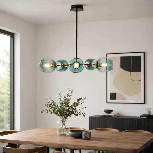 Modern black and gold chandelier with blue glass globes adding elegance and soft luxury lighting to contemporary home interiors.