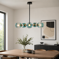 Modern black and gold chandelier with blue glass globes adding elegance and soft luxury lighting to contemporary home interiors.