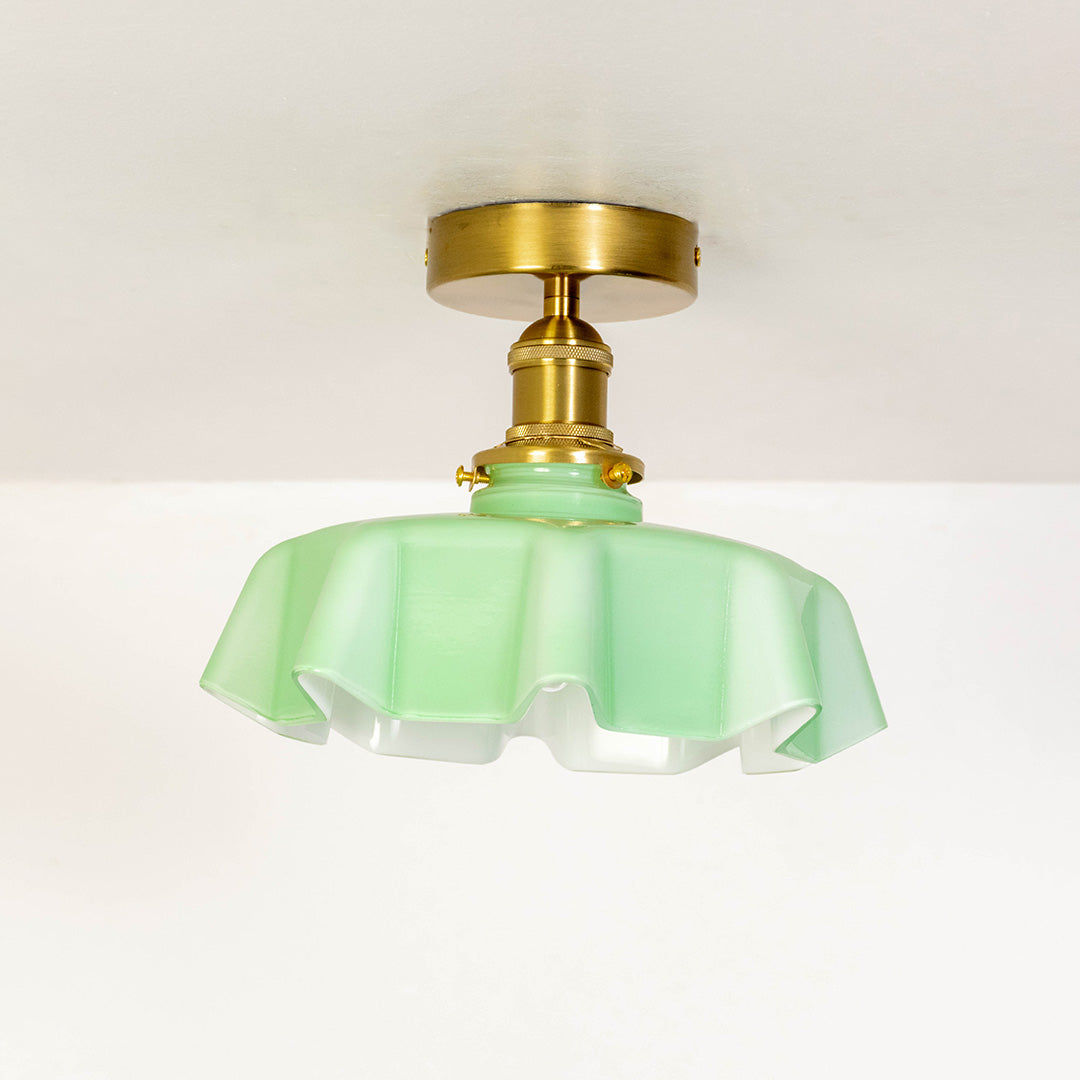 Closeup of mint green glass and gold metal ceiling light for luxury home decor and modern interior styling spaces.