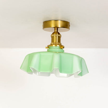 Closeup of mint green glass and gold metal ceiling light for luxury home decor and modern interior styling spaces.