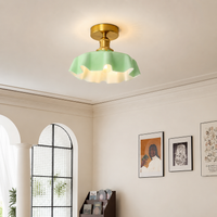 Modern mint green glass ceiling light in dining room setting for elegant interior decor and ambient lighting.