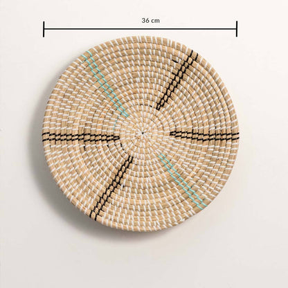 Dimension image of handcrafted natural cream seagrass wall basket with black and teal striped spokes for boho wall decor.