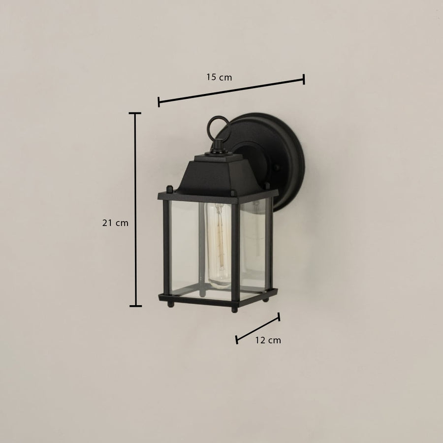A black outdoor wall light shown on a white background with size markings showing 21 cm height 15 cm width and 12 cm depth providing clear installation measurements.