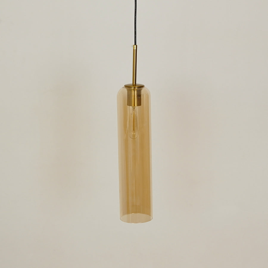 Amber glass pendant light with brass accents adding modern elegance to kitchen ceiling placement.