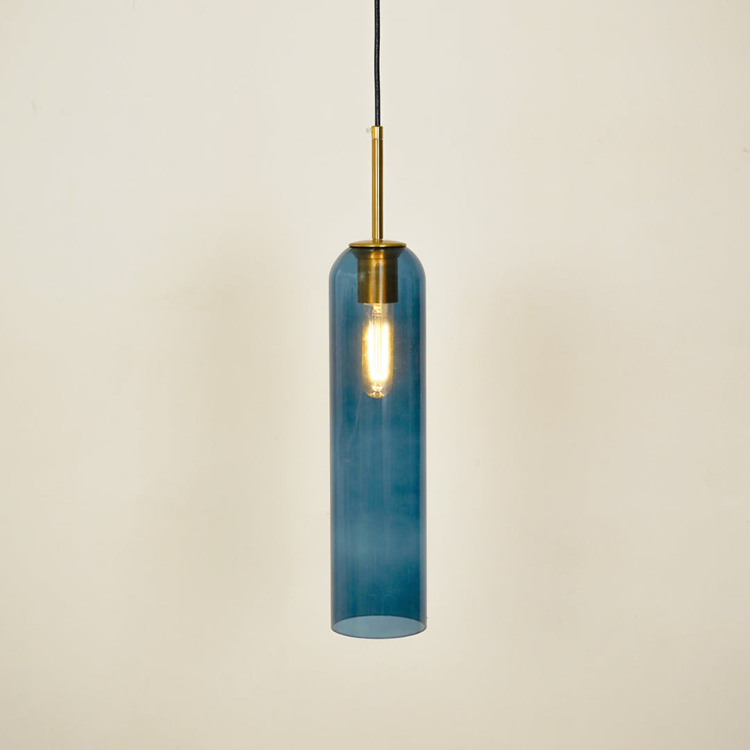 Blue glass pendant light illuminated with warm glow for stylish dining room ceiling decor.