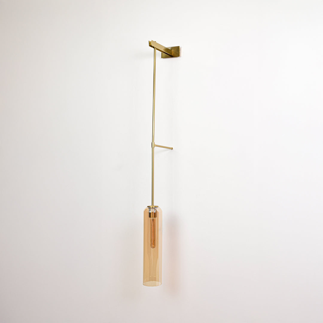 Minimal wall pendant light with gold arm and clear tube shade perfect for modern interior wall decor on clean background.