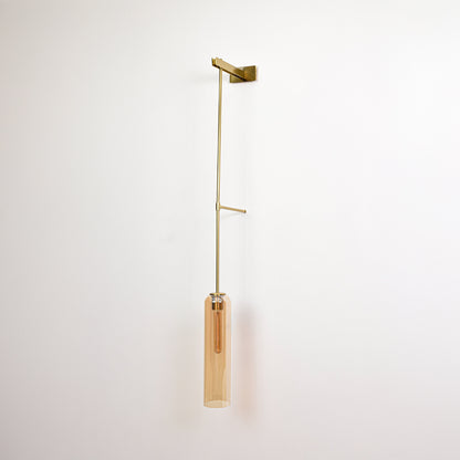 Minimal wall pendant light with gold arm and clear tube shade perfect for modern interior wall decor on clean background.