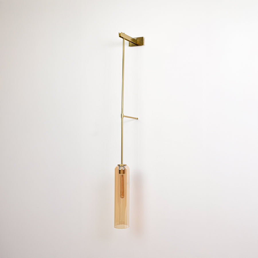 Minimal wall pendant light with gold arm and clear tube shade perfect for modern interior wall decor on clean background.