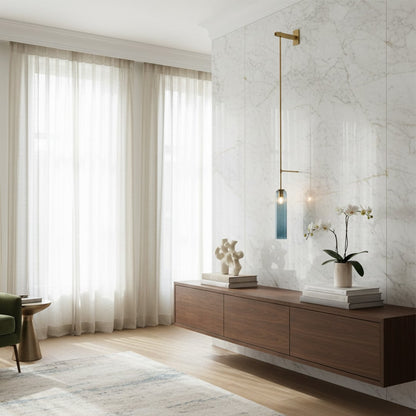Modern gold linear wall sconce lighting fixture casting a warm glow in a beautifully styled minimalist living room decor.