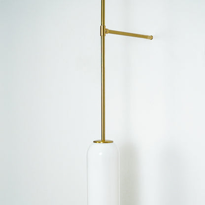 Minimal gold metal wall light with extended arm and hanging tube shade perfect for modern interior wall decor on clean background.