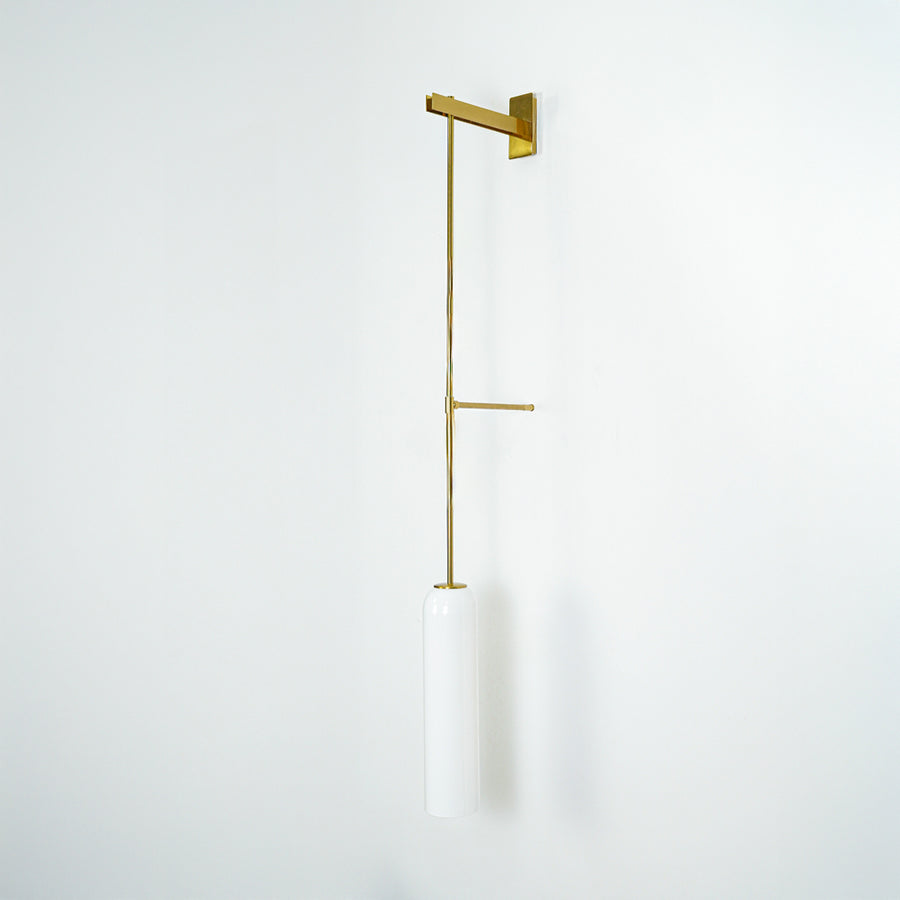 Wall pendant light with gold metal arm and cylindrical white glass shade ideal for modern bedroom or living room wall decor.
