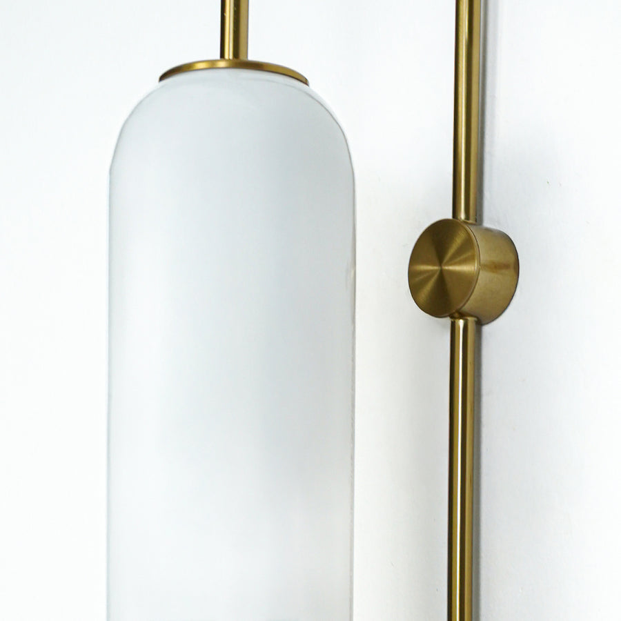 Closeup of white frosted glass and gold metal wall light for modern hallway and premium decor styling spaces.