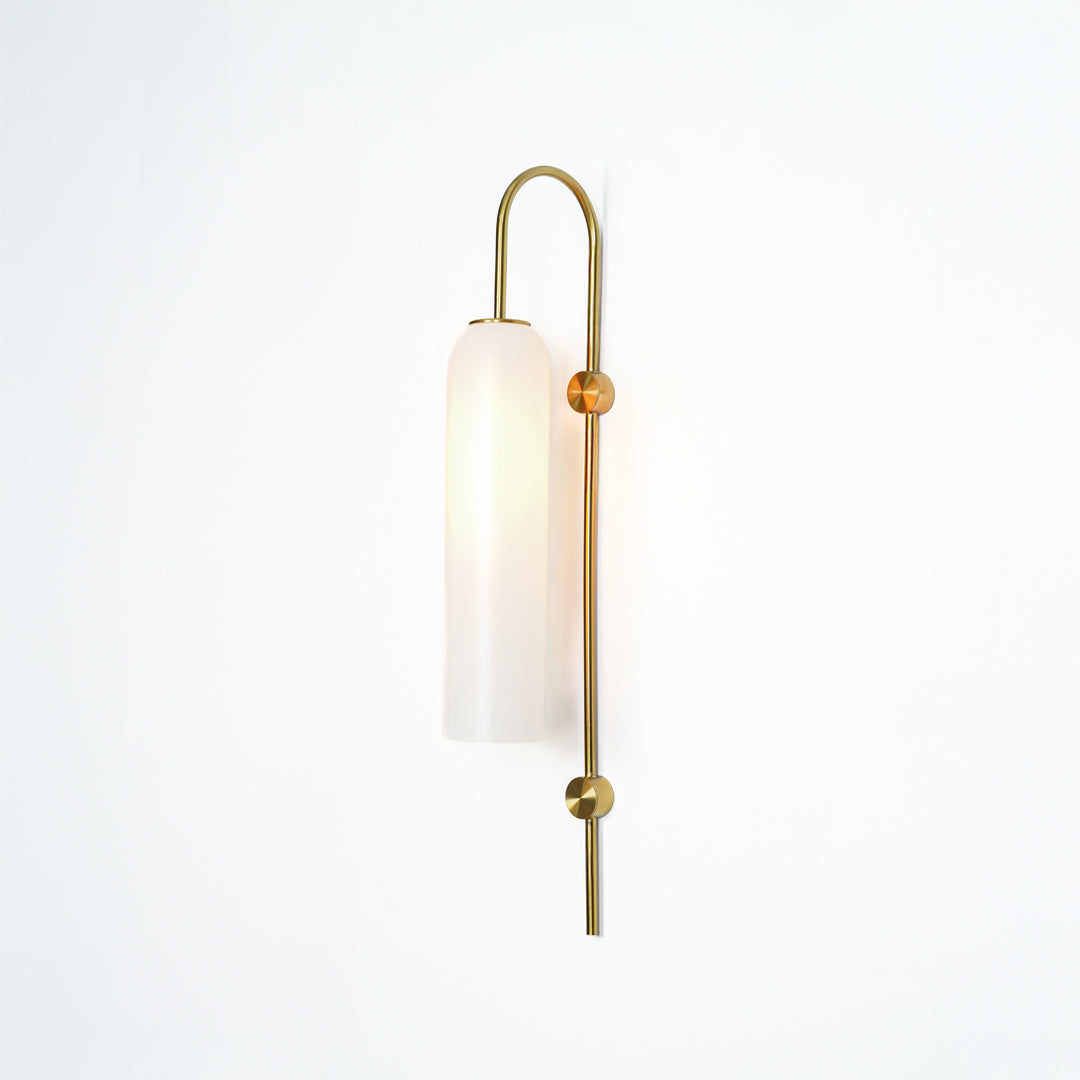 Modern gold metal wall light with white frosted glass shade for stylish bedroom and luxury decor spaces.

