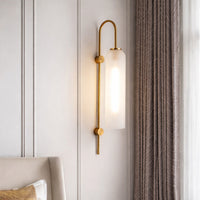 Modern gold metal wall light with frosted glass shade for elegant bedroom and luxury decor styling spaces.