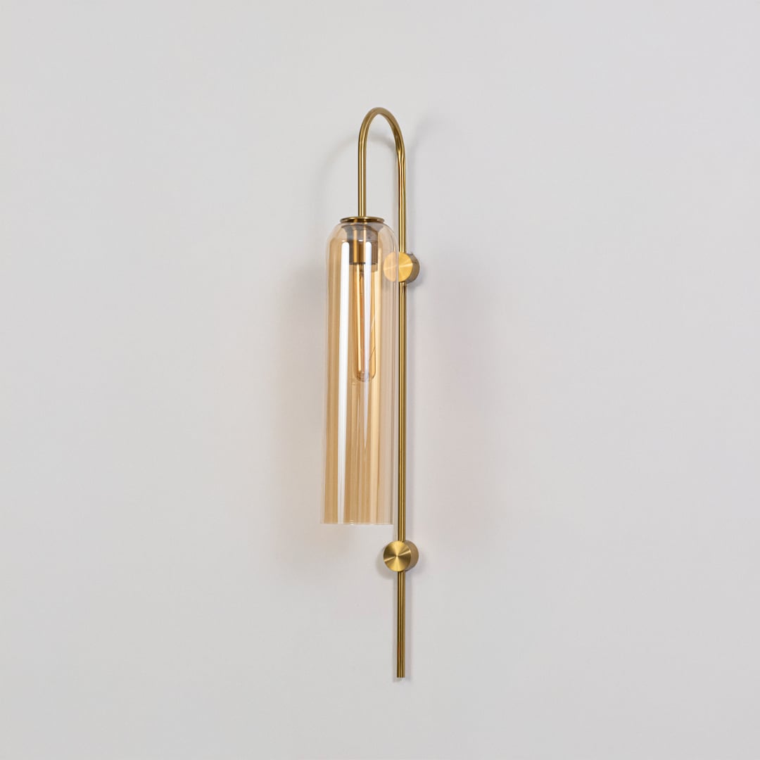 Modern gold metal wall light with clear glass shade for elegant hallway and luxury decor styling spaces.
