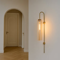 Modern gold metal wall light with warm glow for elegant hallway and luxury decor styling spaces.