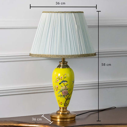 Yellow floral ceramic table lamp with pleated shade on white background featuring dimensions of 58 cm height and 36 cm width for accurate size reference.