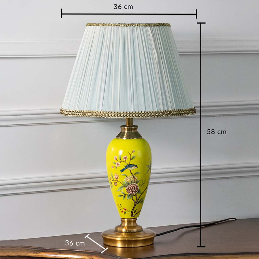 Yellow floral ceramic table lamp with pleated shade on white background featuring dimensions of 58 cm height and 36 cm width for accurate size reference.