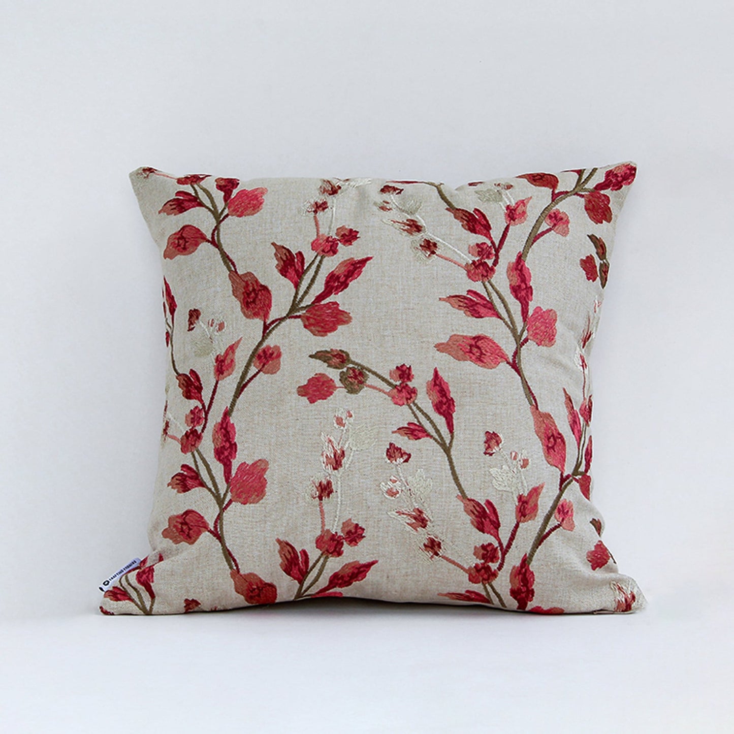 Floral cushion cover with red branch pattern displayed on white background highlighting fabric texture color detail and square shape.