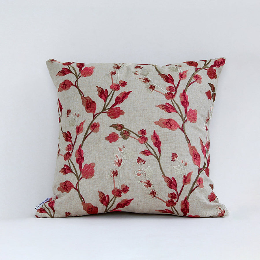 Floral cushion cover with red branch pattern displayed on white background highlighting fabric texture color detail and square shape.