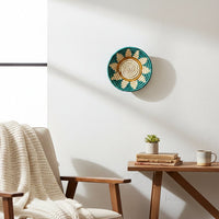 Green woven wall basket displayed above a wooden table for elegant bohemian wall decor and cozy home interiors.
