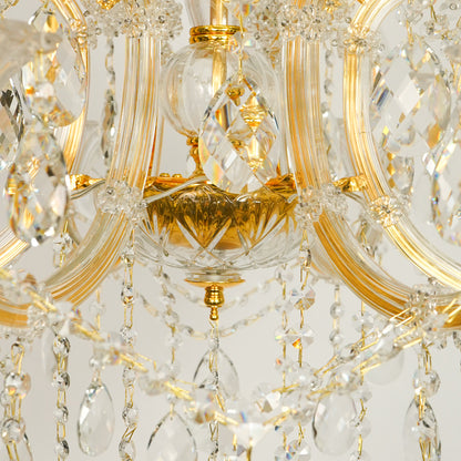 Closeup image of gold metal candle style chandelier for modern dining room decor styling with elegant crystal detailings.