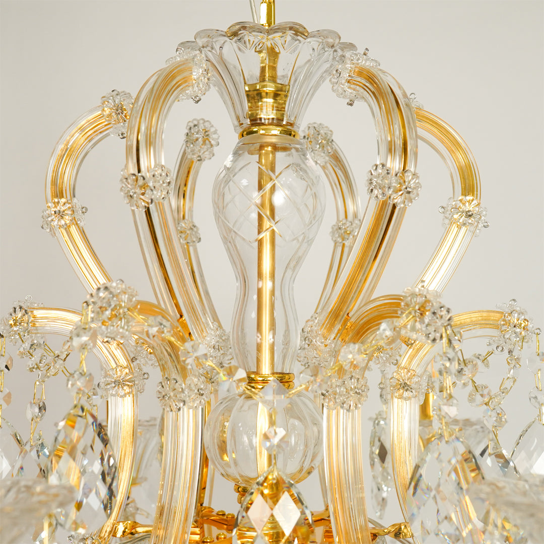 Closeup image of gold metal candle style chandelier for elegant living room decor styling with beautiful crystal accents.