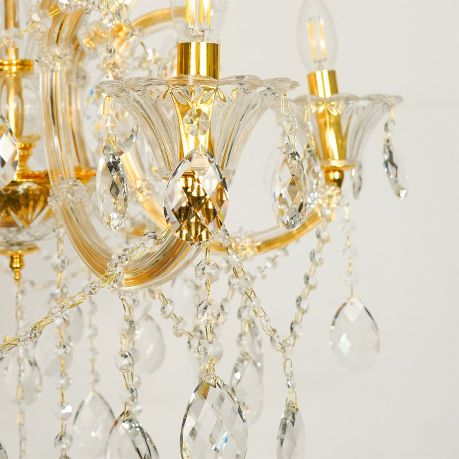 Closeup image of gold metal candle style chandelier for luxury living room decor styling with polished gold metal finish.