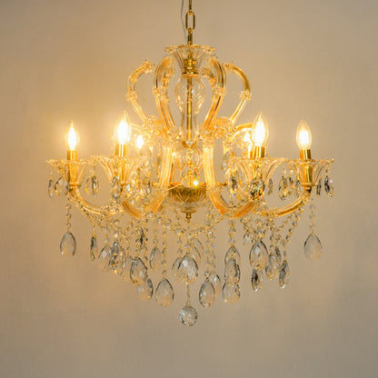 White background image of gold metal candle style chandelier for modern living room decor styling with a bright warm glow.